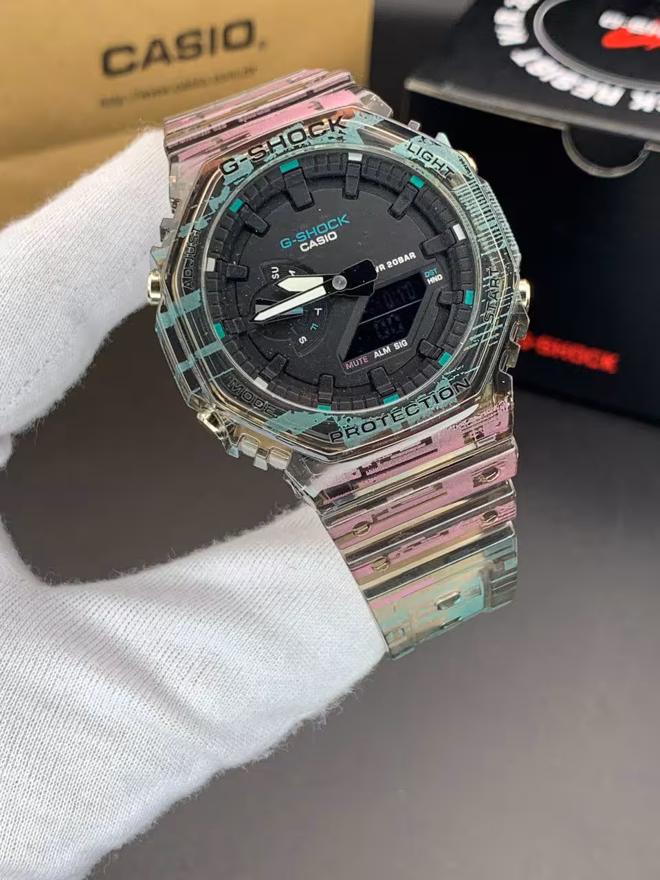 ساعت مچی کاسیو جیشاک مدل GA-2100 صفحه مشکی دور شفاف بند رنگی