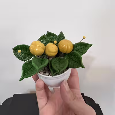 گلدان به همراه گل مصنوعی مدل میوه ای