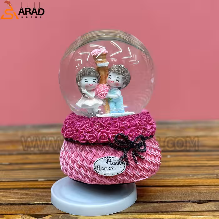 گوی موزیکال متوسط طرح دختر و پسر صورتی و دسته گل