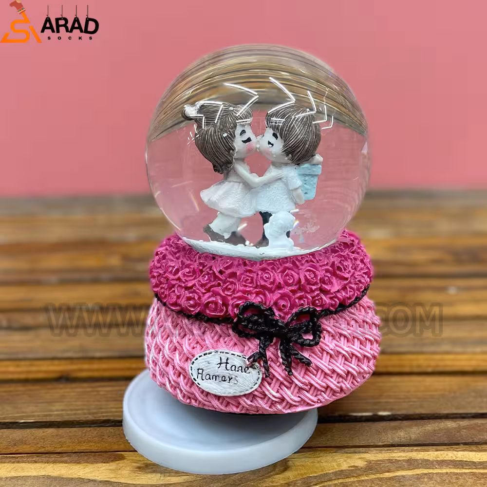 گوی موزیکال متوسط طرح دختر و پسر صورتی و بوسه