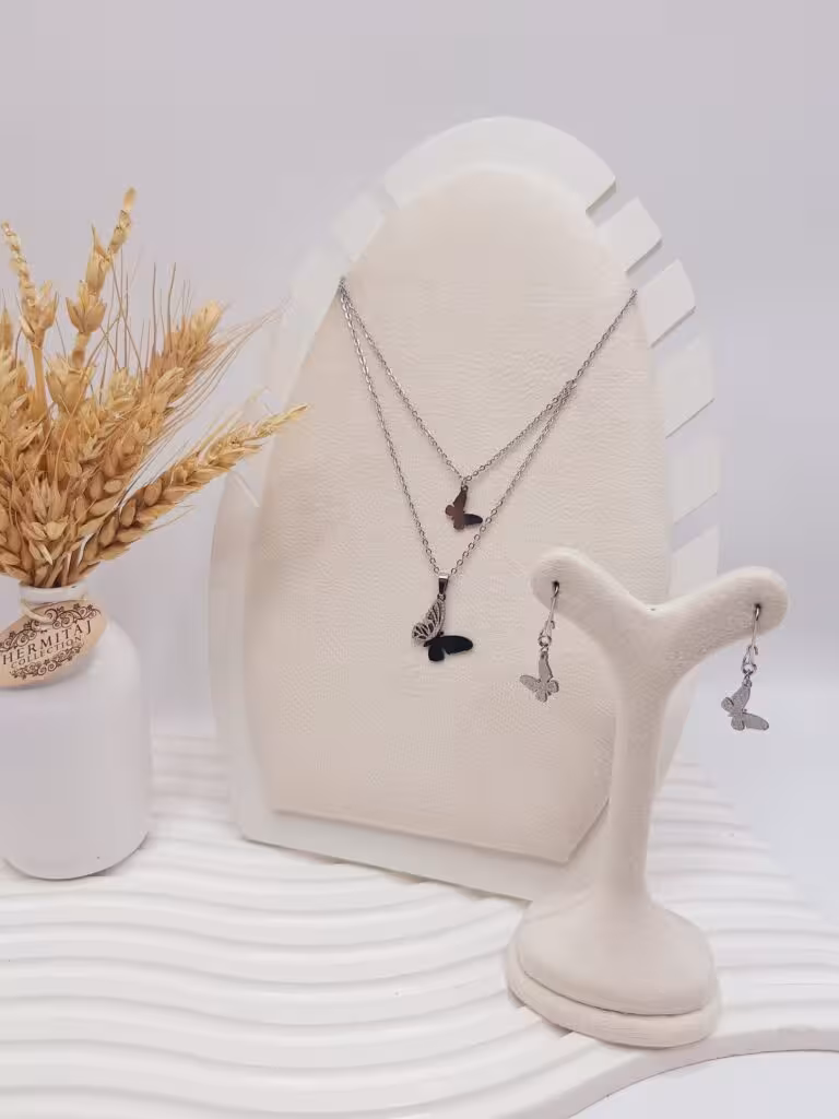 ست گوشواره و گردنبند 2 لاین طرح پروانه مخرج کاری نقره ای استیل