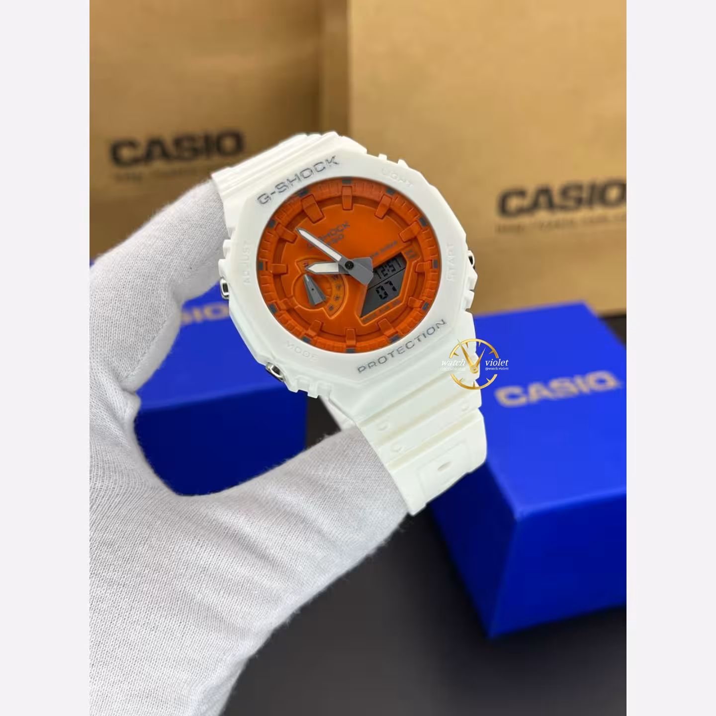 ساعت مچی کاسیو جیشاک صفحه نارنجی خوش رنگ بدنه و بند سفید عقربه سفید