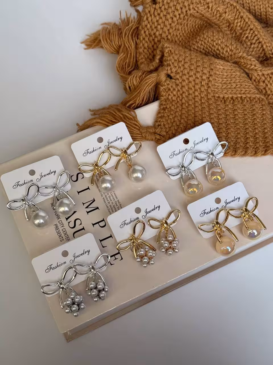 کالکشن گوشواره پاپیون مرواریدی1137گوشواره/وارداتی/کیفیت بالا/جنس ابکاری رادیوم/ضدحساسیت/سبک درگوش