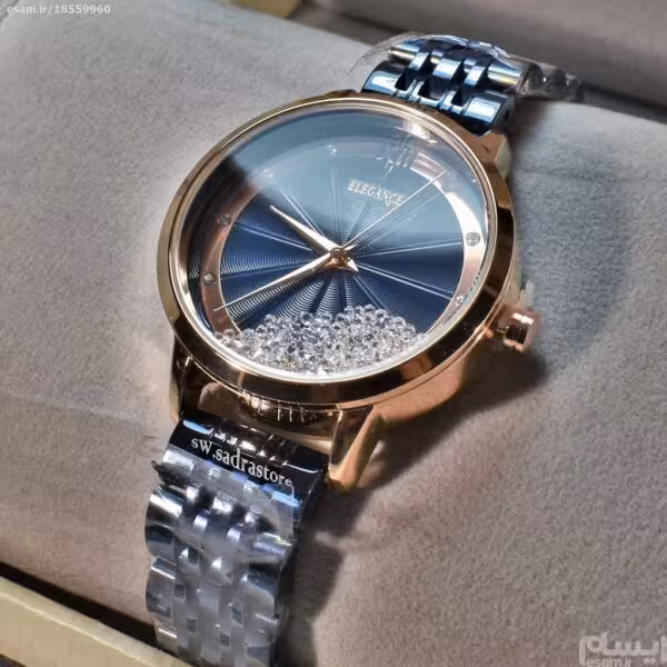 ELEGANCE 88063 ساخت ژاپن الگانس زنانه موتور ژاپن با صفحه پرنگین دار براق ،، بند سرمه ای رنگ ثابت ،، قاب مسی