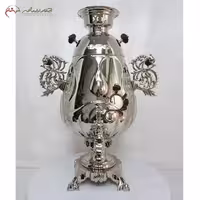 سماور ذغالی 9 لیتری مستر جام با بدنه ی ریخته گری شده با پایه های مشبک و سر شیر های طرح اژدها، کد 114
