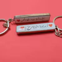 سر کلیدی رزینی پلاک ماشین با قاب استیل رنگ نقره ای  