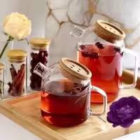 قوری و روغن‌ریز از جنس پیرکس با درب دکمه‌ای، حجم 1200 میلی‌لیتر