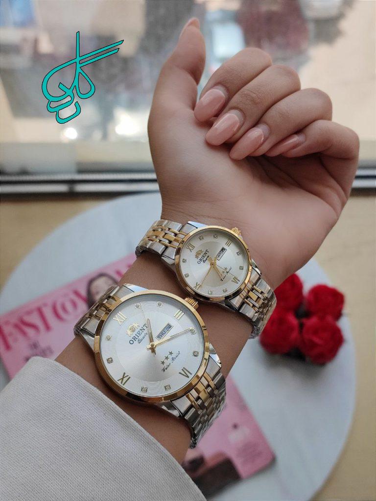 خرید ست ساعت مردانه زنانه اورینت تقویم دار رنگ ثابت دارای قفل ضامن دار دارای رنگ بندی متنوع کد 2115678 - ردگل
