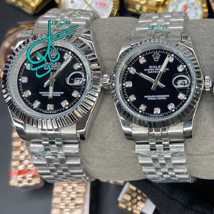 خرید ست ساعت زنانه و مردانه رولکس موتور ژاپن رنگ سیلور صفحه مشکی ایندکس نگینی کیفیت عالی رنگ ثابت سایز بزرگ کد 2116112 - ردگل