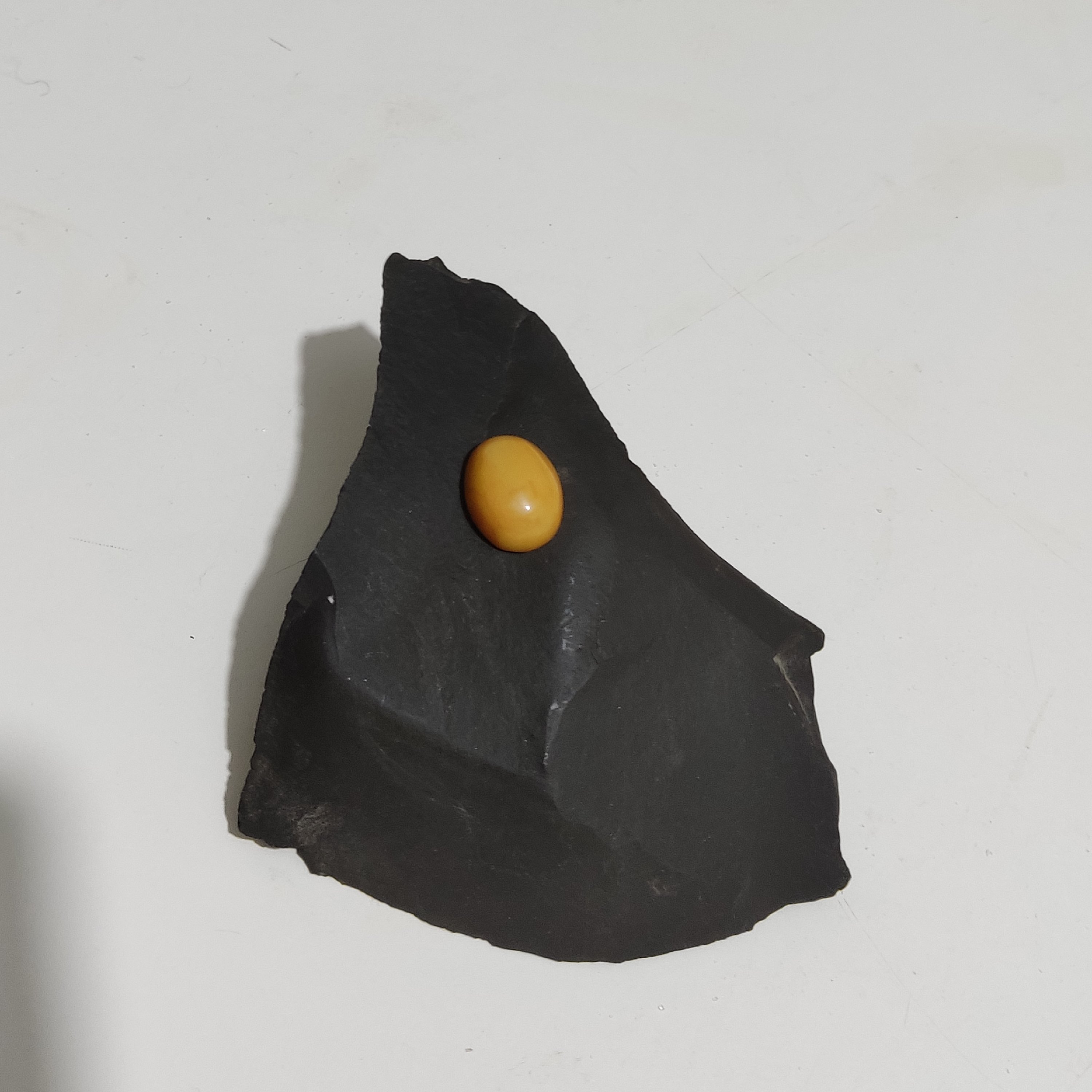 نگین انگشتری از سنگ جاسپر یا عقیق مات به رنگ زرد با تراش دامله به شکل بیضی