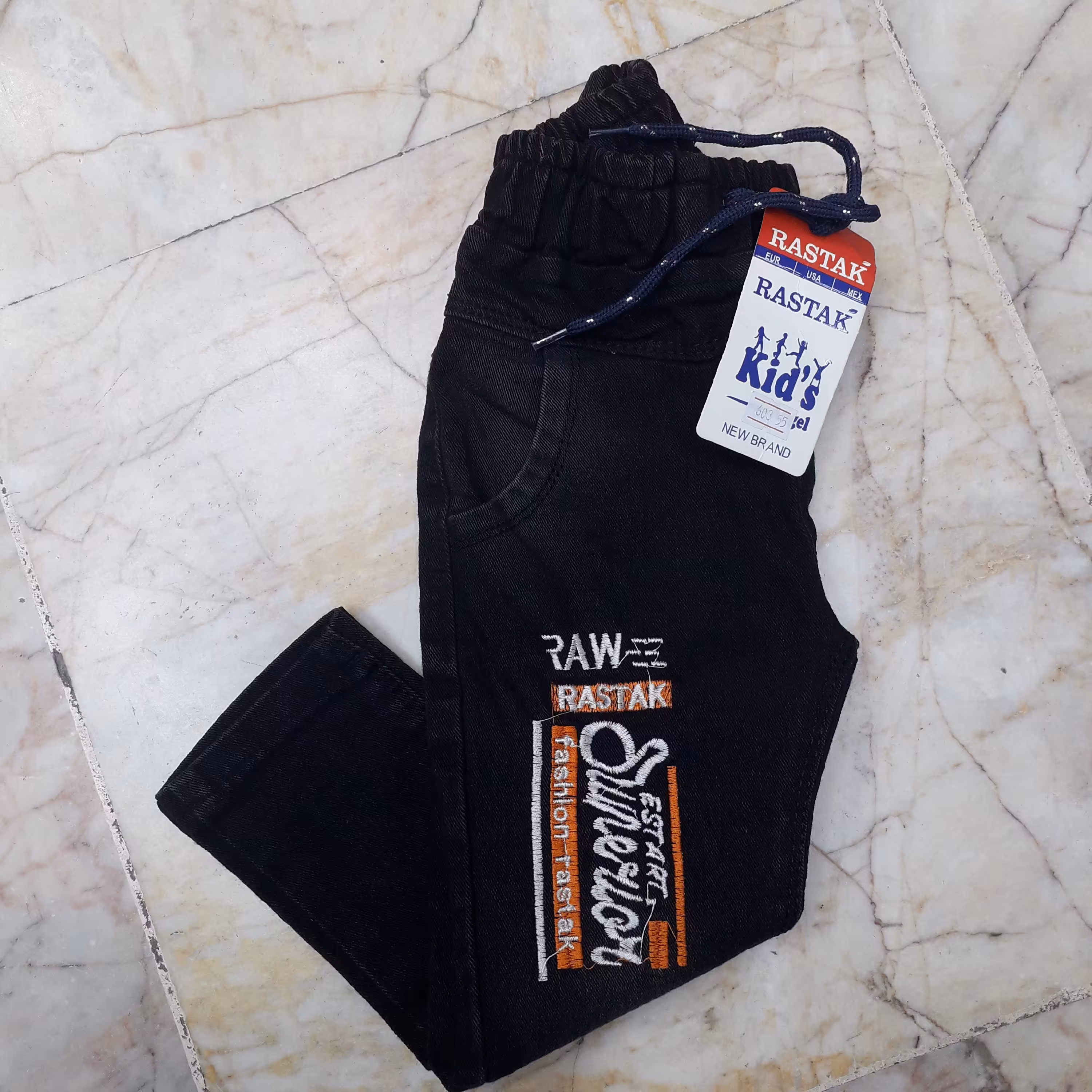 شلوار لی کمر کش دم پا ساده زغالی طرح دار  مناسب 2 سال و  6 سال  ضمانت کیفیت و قیمت