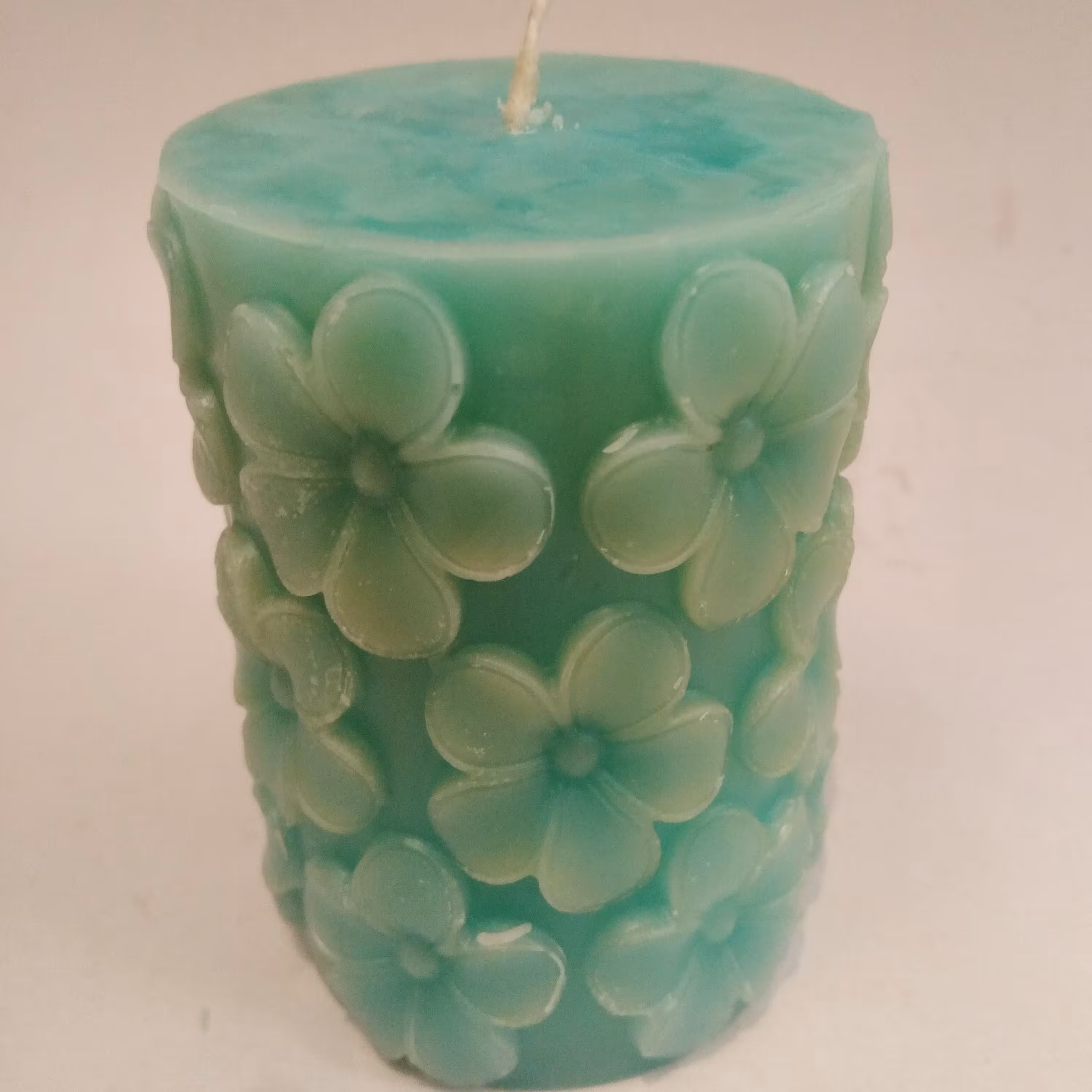 شمع استوانه طرح گل(7پرتو) معطر، رنگ فیروزه ای