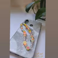 آویز گوشی مهره ایphone charm رنگبندی زرد و نارنجی