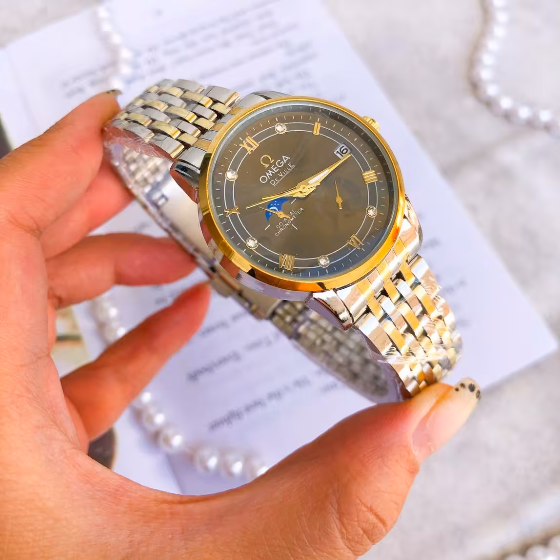 ساعت تک زنانه یا مردانه امگا بند استیل دو رنگ صفحه مشکی مایل به خاکستری