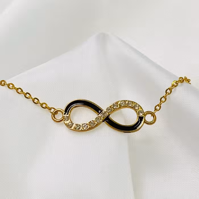دستبند مدل بینهایت مشکی طلایی با نگین مناسب دستهای تپل