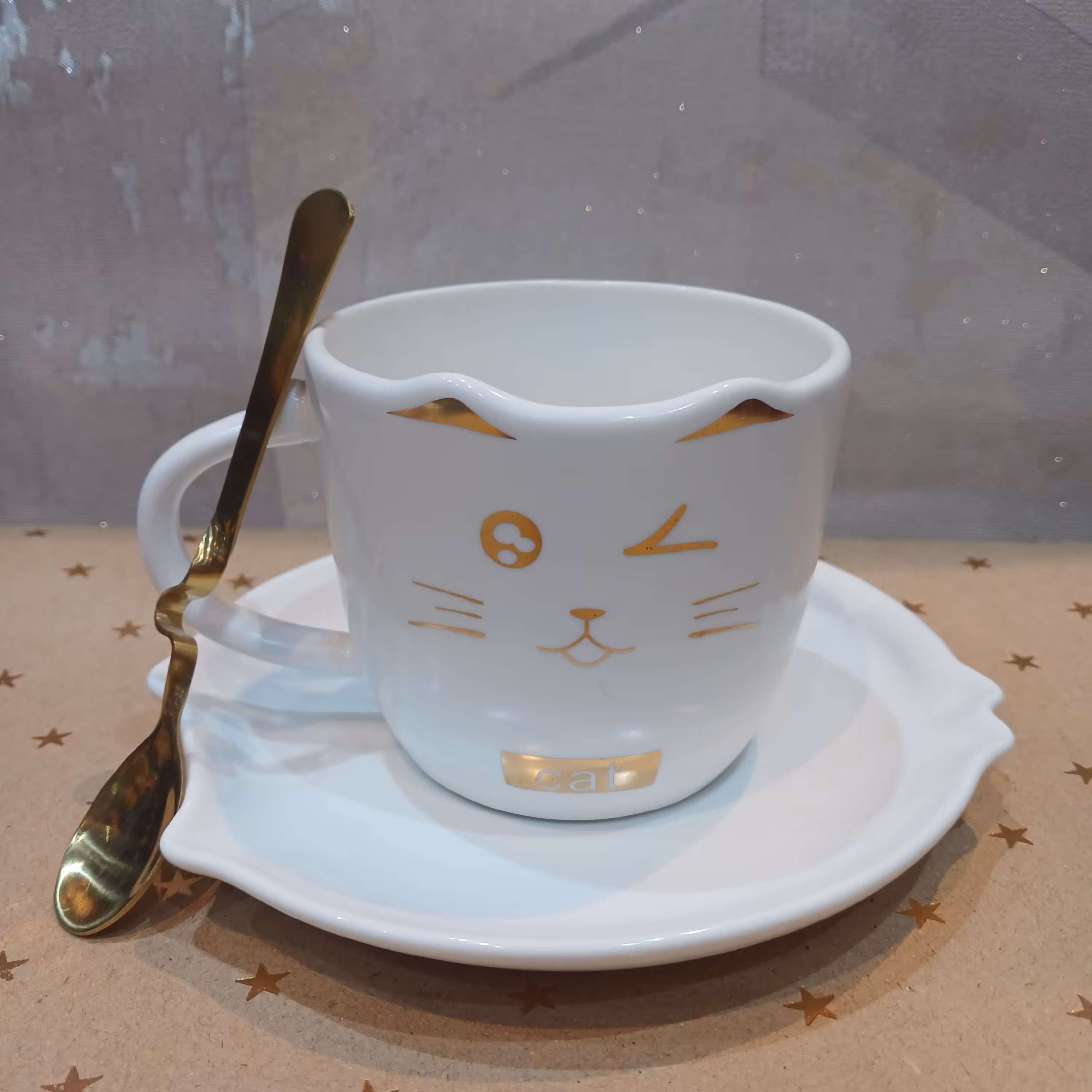 ماگ  زیری دار و قاشق دار سرامیکی سفید و طلایی طرح گربه چشمک زن کار بسیار زیبا و شیک مناسب چای و قهوه و سایر نوشیدنیها