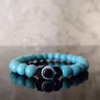 دستبند سنگ فیروزه و هماتیت طرح فلش و مهره چشم نظر مردانه و زنانه 