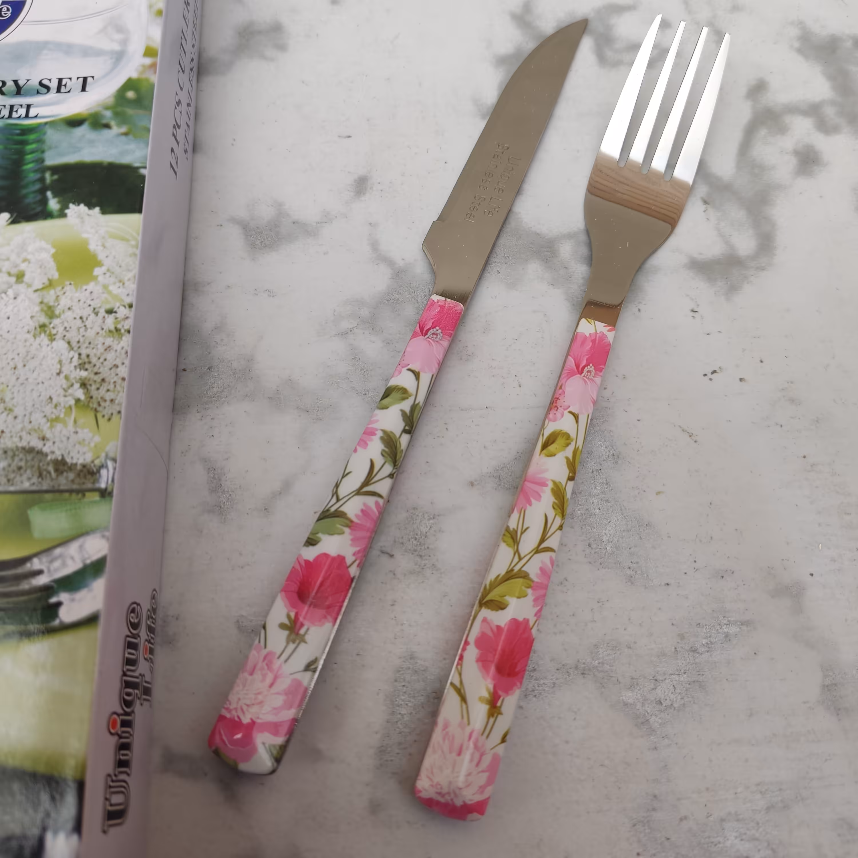 کارد و چنگال میوه خوری طرح سرامیکی مارک یونیک تیغه استیل 12 عددی گل صورتی 