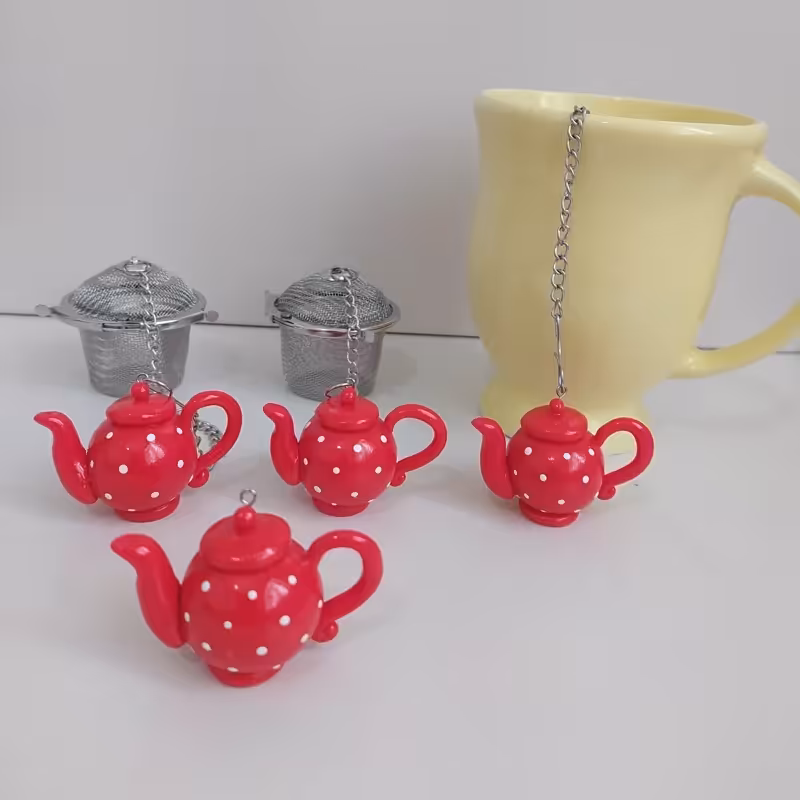 آویز صافی چای و دمنوش  طرح قوری بدون صافی استیل میباشد | amazonchi