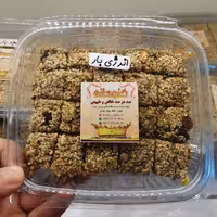 انرژی بار کنجدانه تهیه شده با عسل(مغز آفتاب گردان،کنجد، بادام زمینی، پسته، کشمش) 