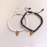 ست دستبند سفید و مشکی کریستالی با خرجکار برگ طلایی