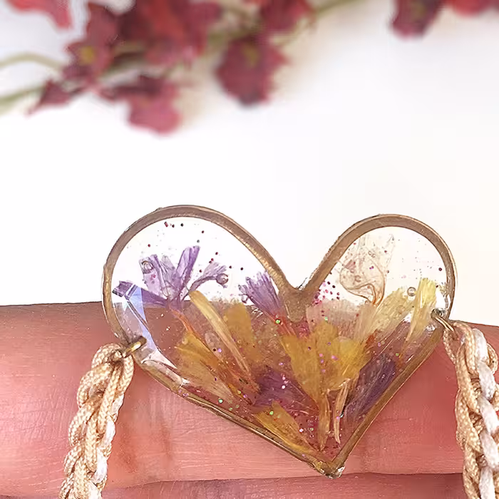 دستبند رزینی قلبی با بند دستبافت کشویی 