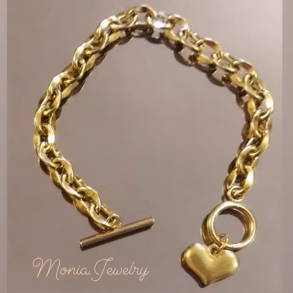 دستبند استیل هرمس  ( زنجیر بیضی) با قفل تی و آویز قلب توپر رنگ ثابت تضمینی ضدحساسیت 