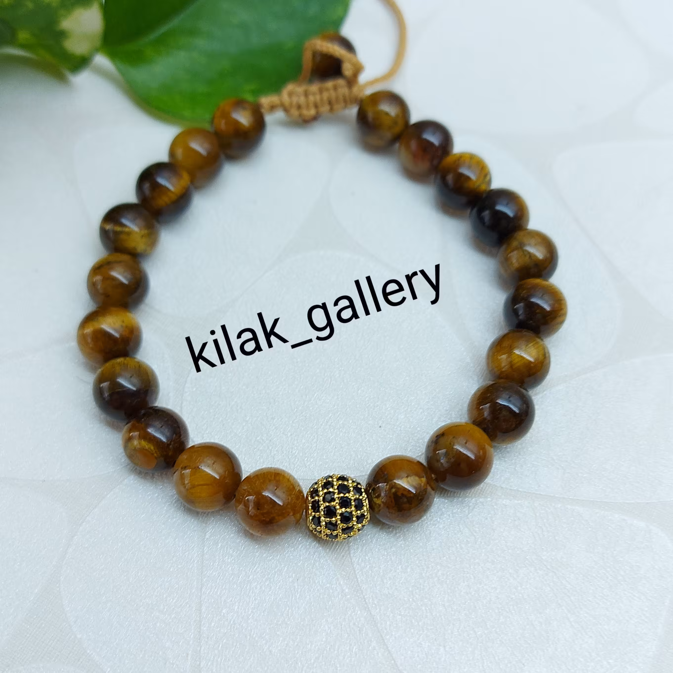 دستبند سنگ چشم ببر قهوه ای و گوی نگین دار از برند سوارسکی