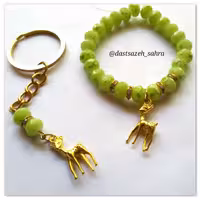 دستبند و جاکلیدی کریستال سبز و پلاک برنجی آهو