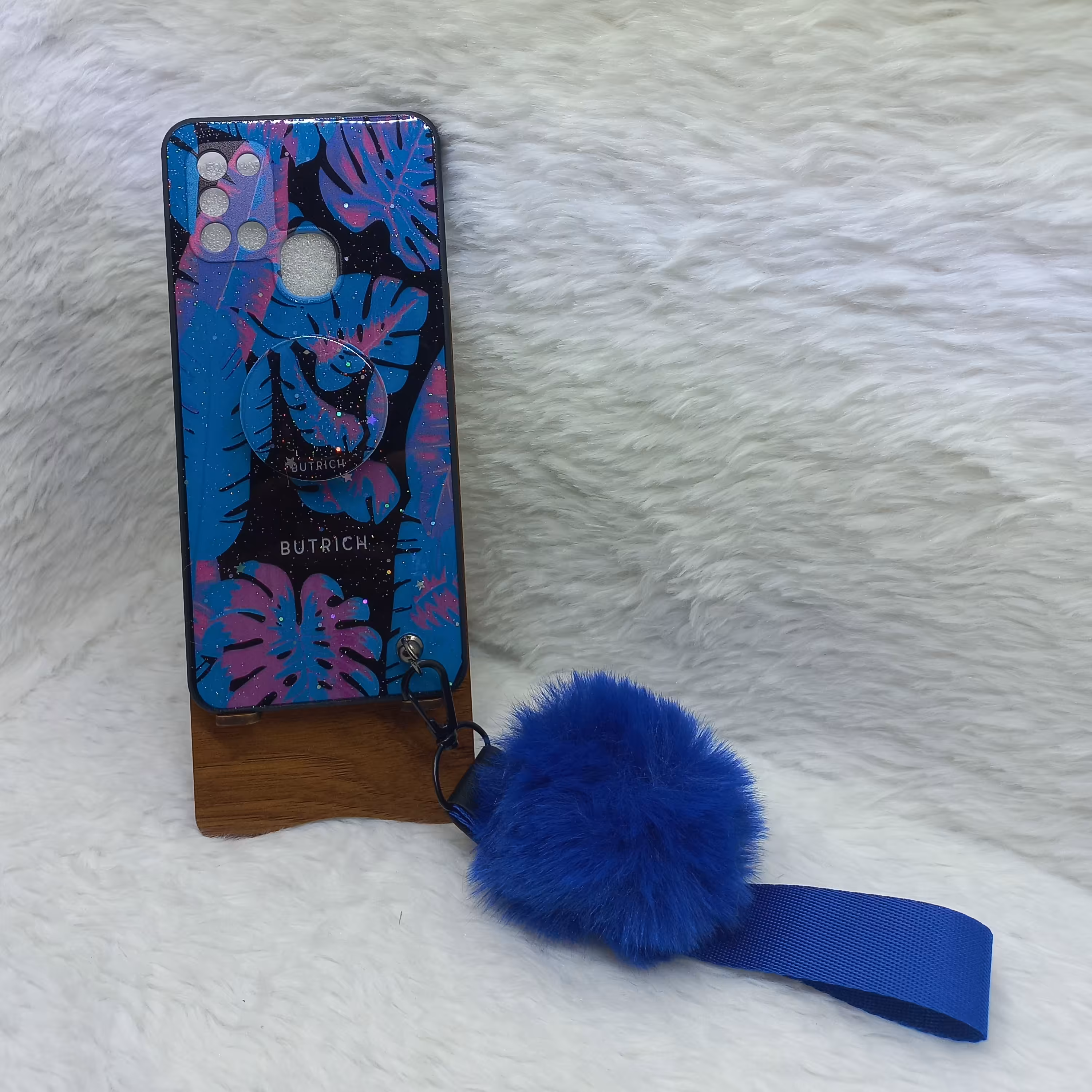 گارد (قاب) گوشی دخترانه A21s مدل پام پام به همراه بند پام و پاپ سوکت طرح برگ آبی مناسب گوشی Samsung A21s