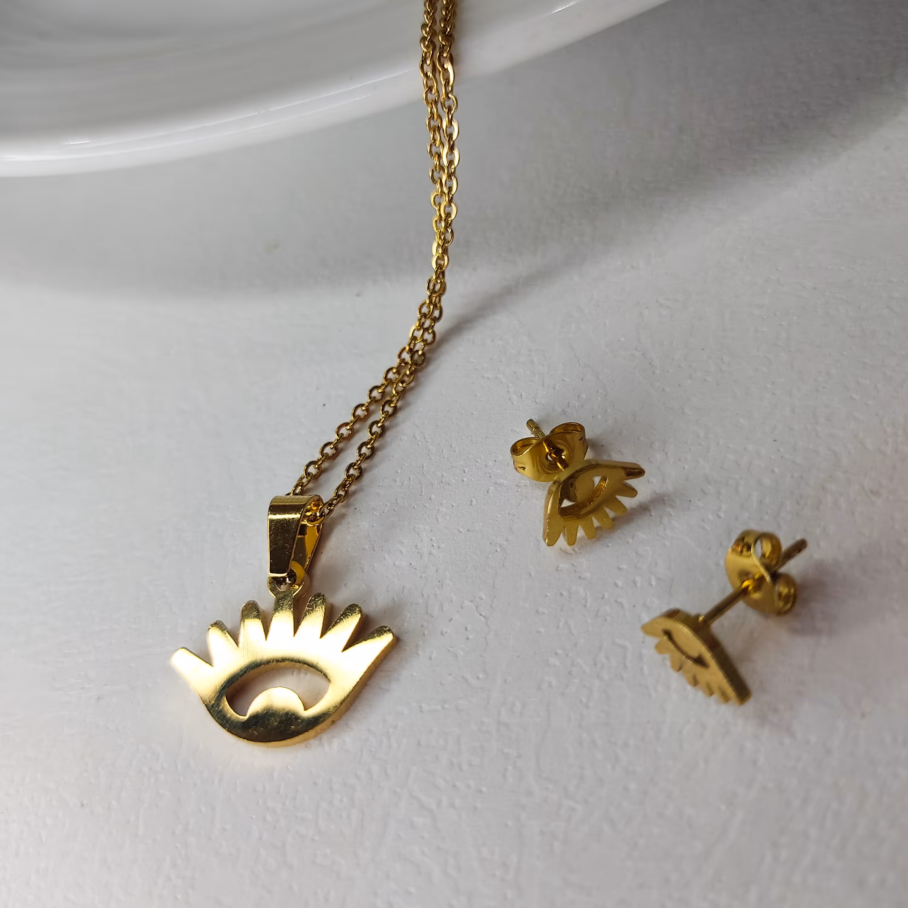 نیم ست گردنبند و گوشواره  طلایی استیل طرح چشم نظر 