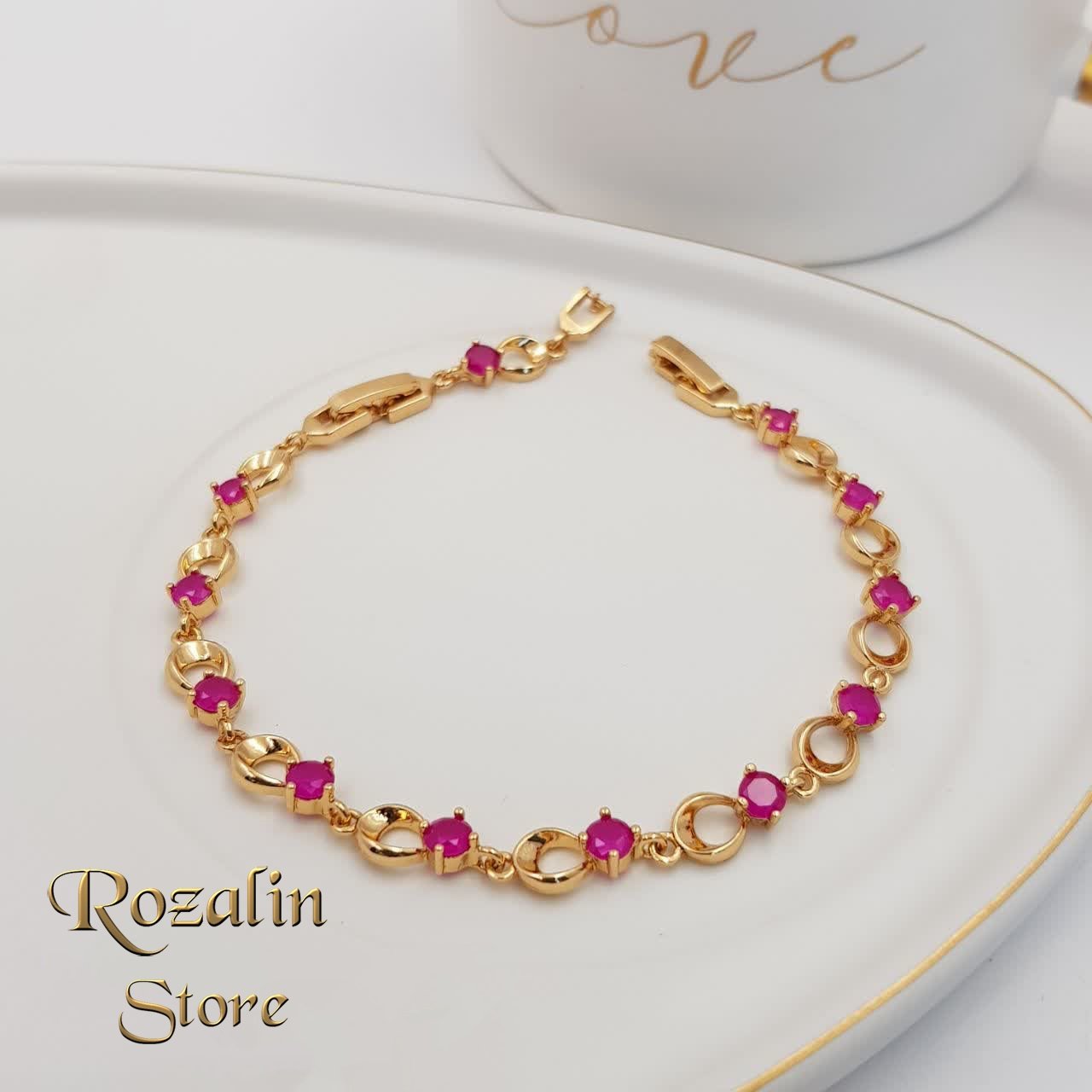 دستبند زنانه ژوپینگ طلایی با نگین صورتی