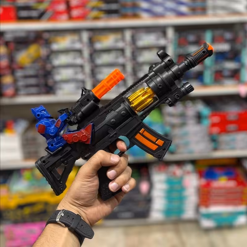 اسباب بازی تفنگ موزیکال ادمک دار سلفونی 1030