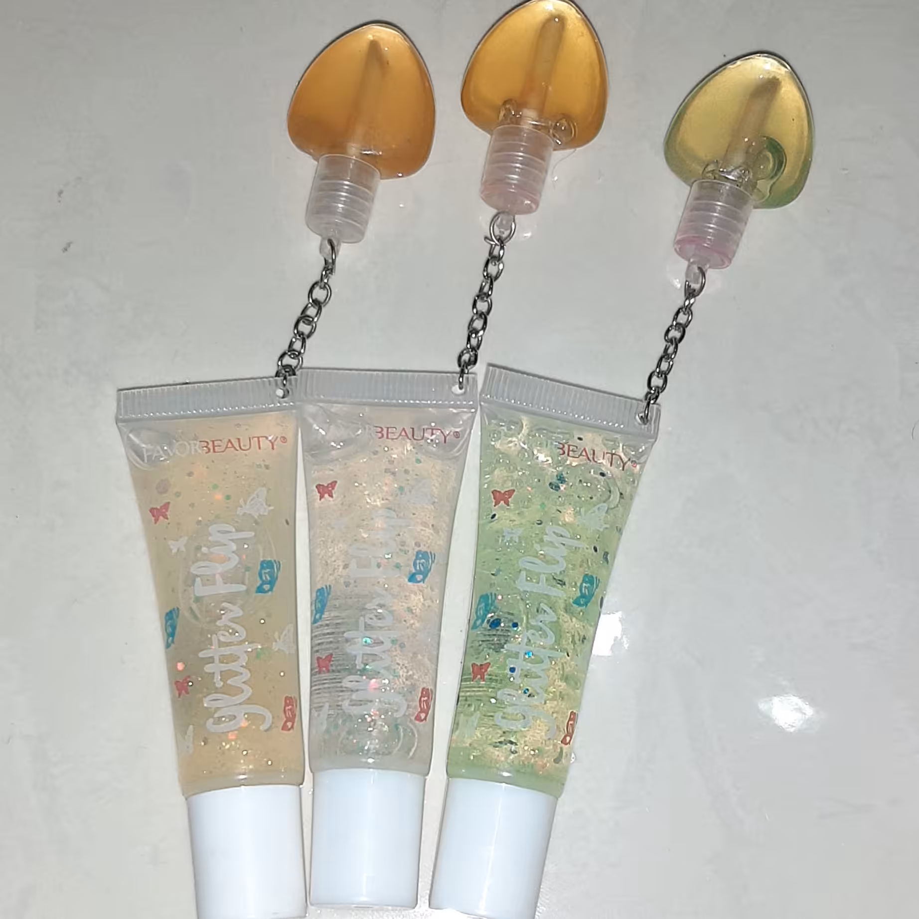 بالم لب  دوقلو گوشواره ای برق لب و لیپ گلاس حرارتی آویزدار
