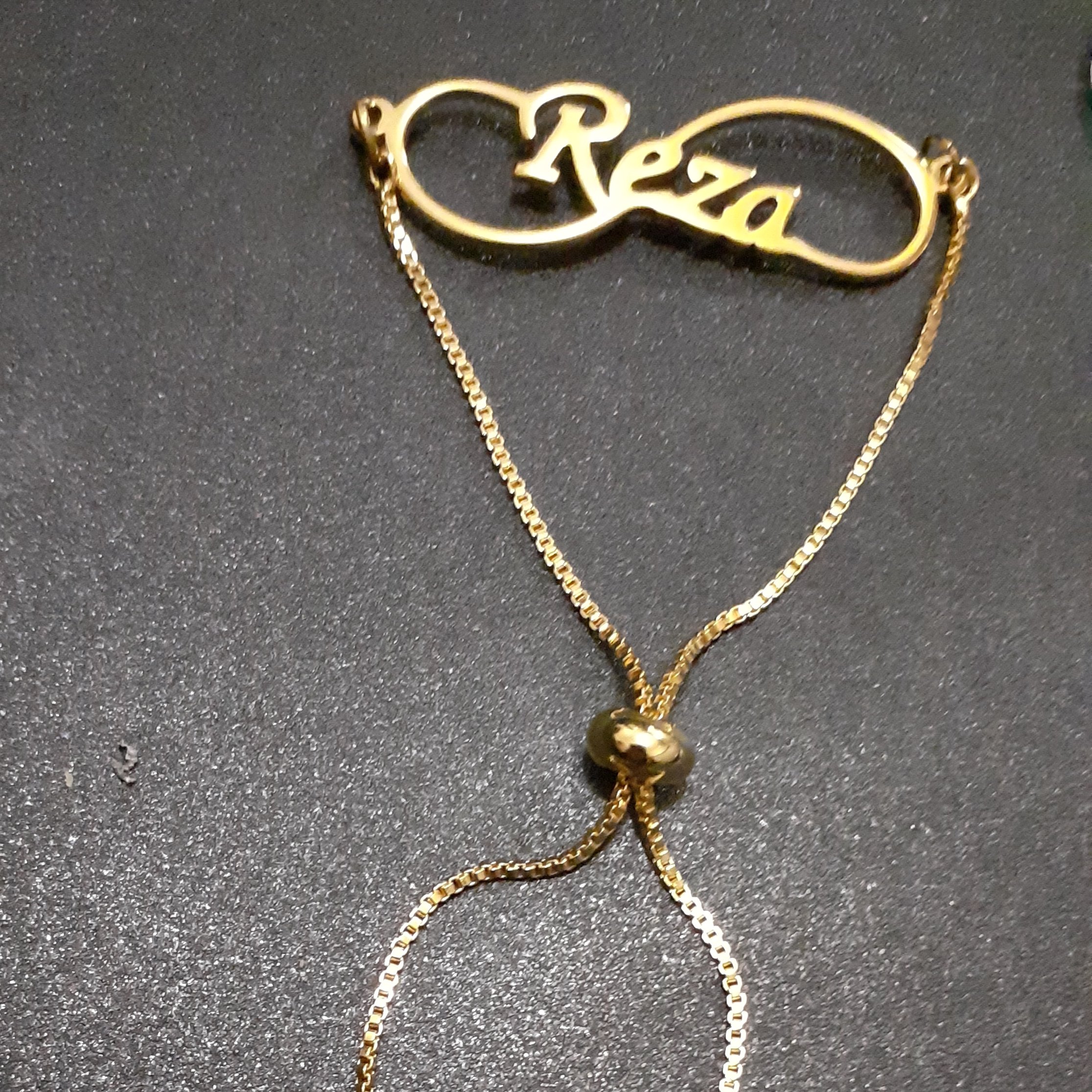 دستبند با قفل  اسانسوری و پلاک اسم رضا لاتین  بینهایت کد 5689