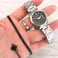 ست ساعت کاسیو زنانه و دستبند و حلقه استیل نقره ای صفحه مشکی