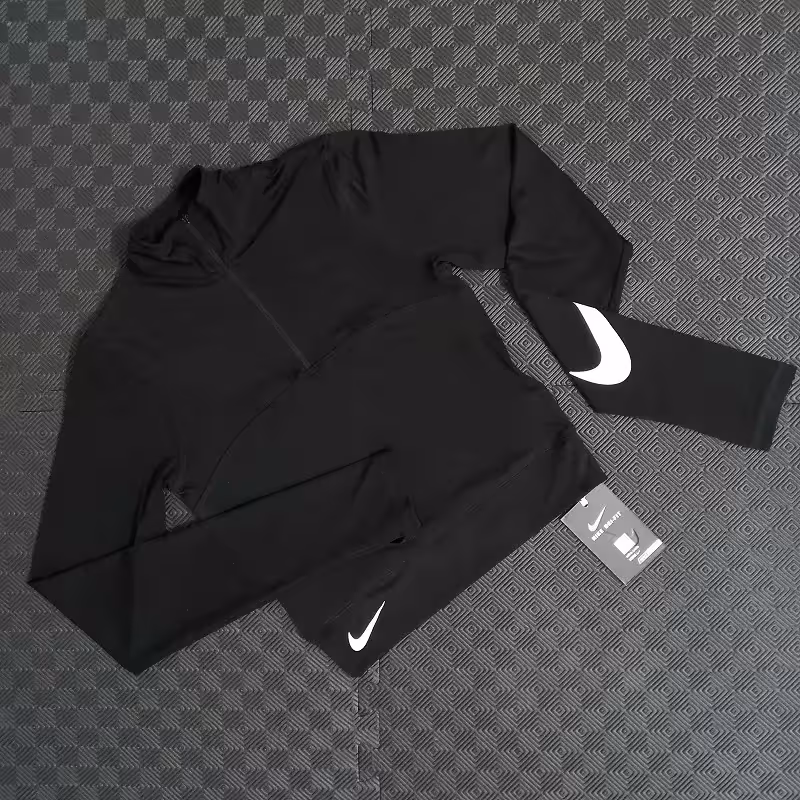 کراپ ورزشی زنانه فینگری نیم زیپ نایک