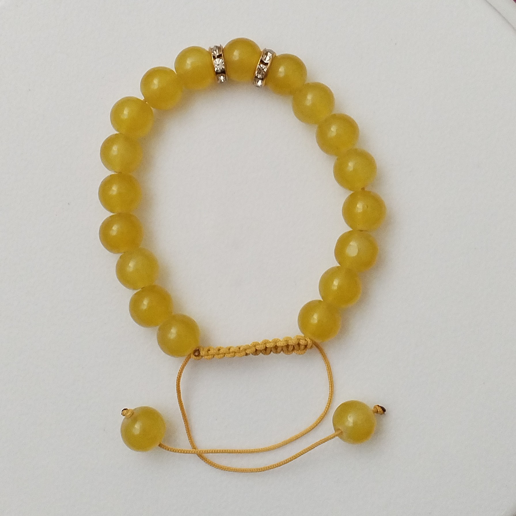 یک عدد دستبند منگوله ای رنگ زرد براق