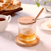 عسل خوری شیشه ای همراه با قاشق چوبی