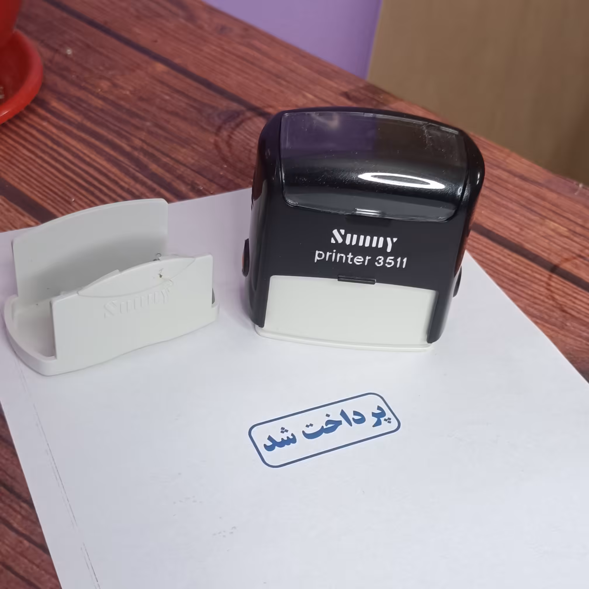 پایه مهر سانی طرح پرداخت شد مدل 3511 رنگ جوهر آبی - رنگ دستگاه قرمز و مشکی و آبی