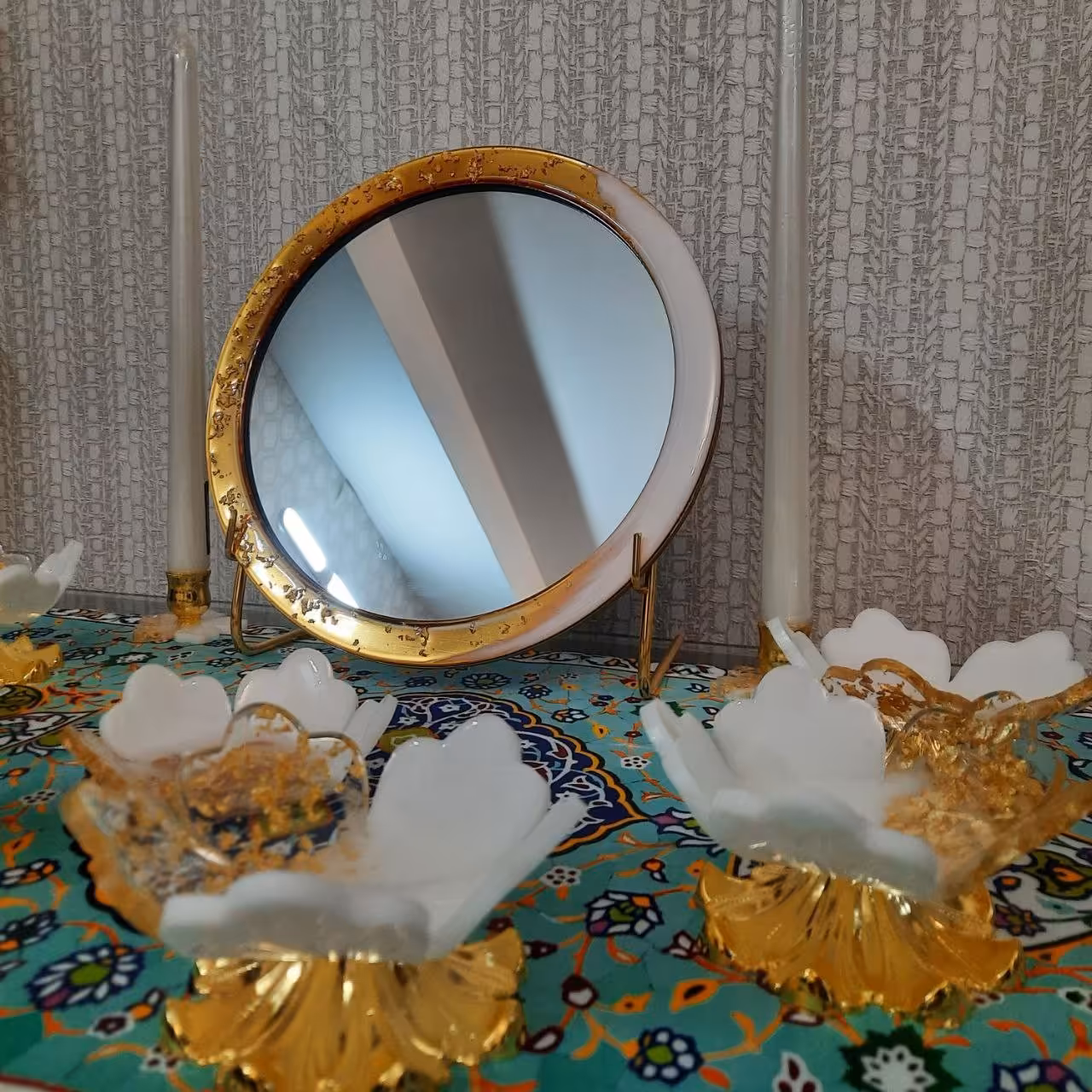 هفت سین رزینی طلا ساخته شده از ورق طلا ،پایه آینه فلزی آبکاری شده،پایه ی کار طرح زنبق است 