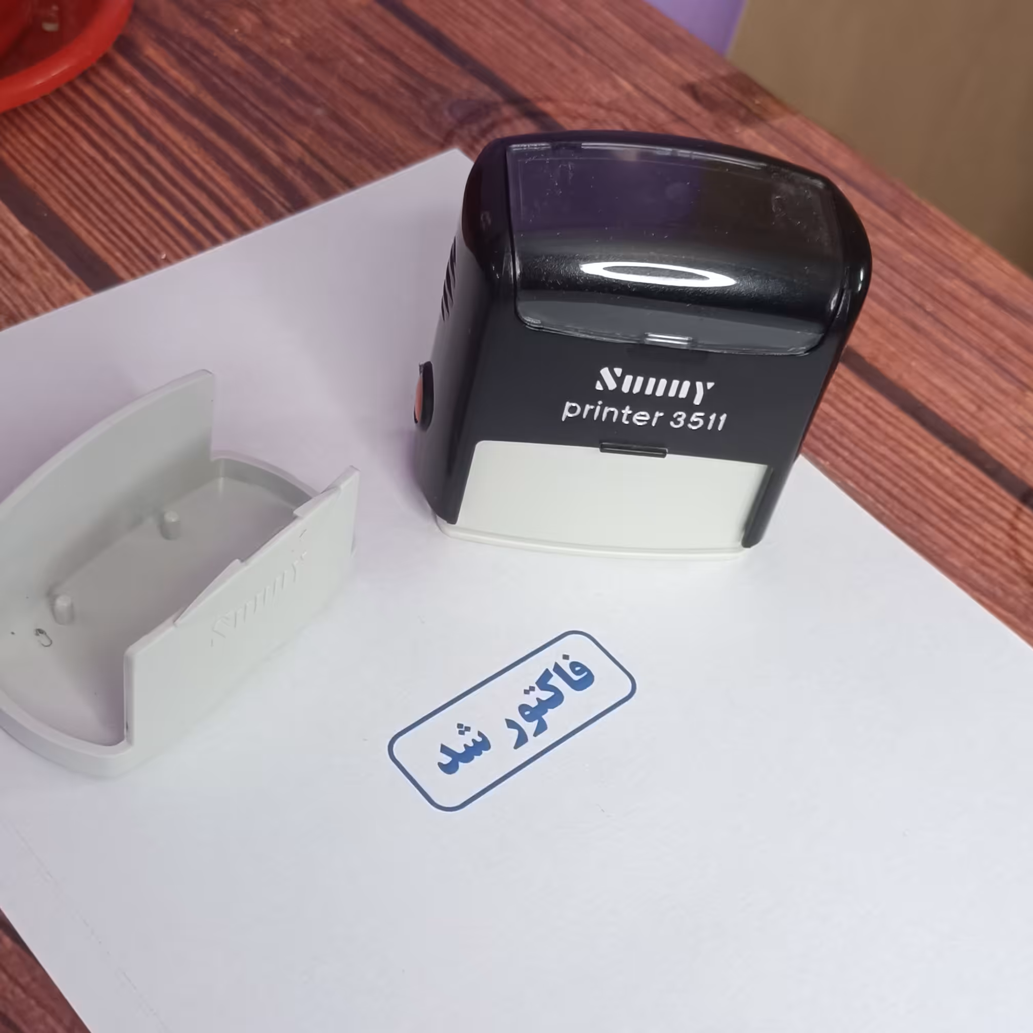 پایه مهر سانی طرح فاکتور شد مدل 3511 رنگ جوهر آبی - رنگ دستگاه قرمز و مشکی و آبی