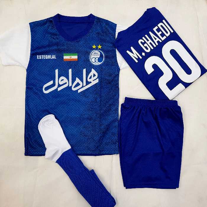 کیت ورزشی استقلال-همراه با جوراب ورزشی- سایزبندی بچگانه شماره 50 الی 80