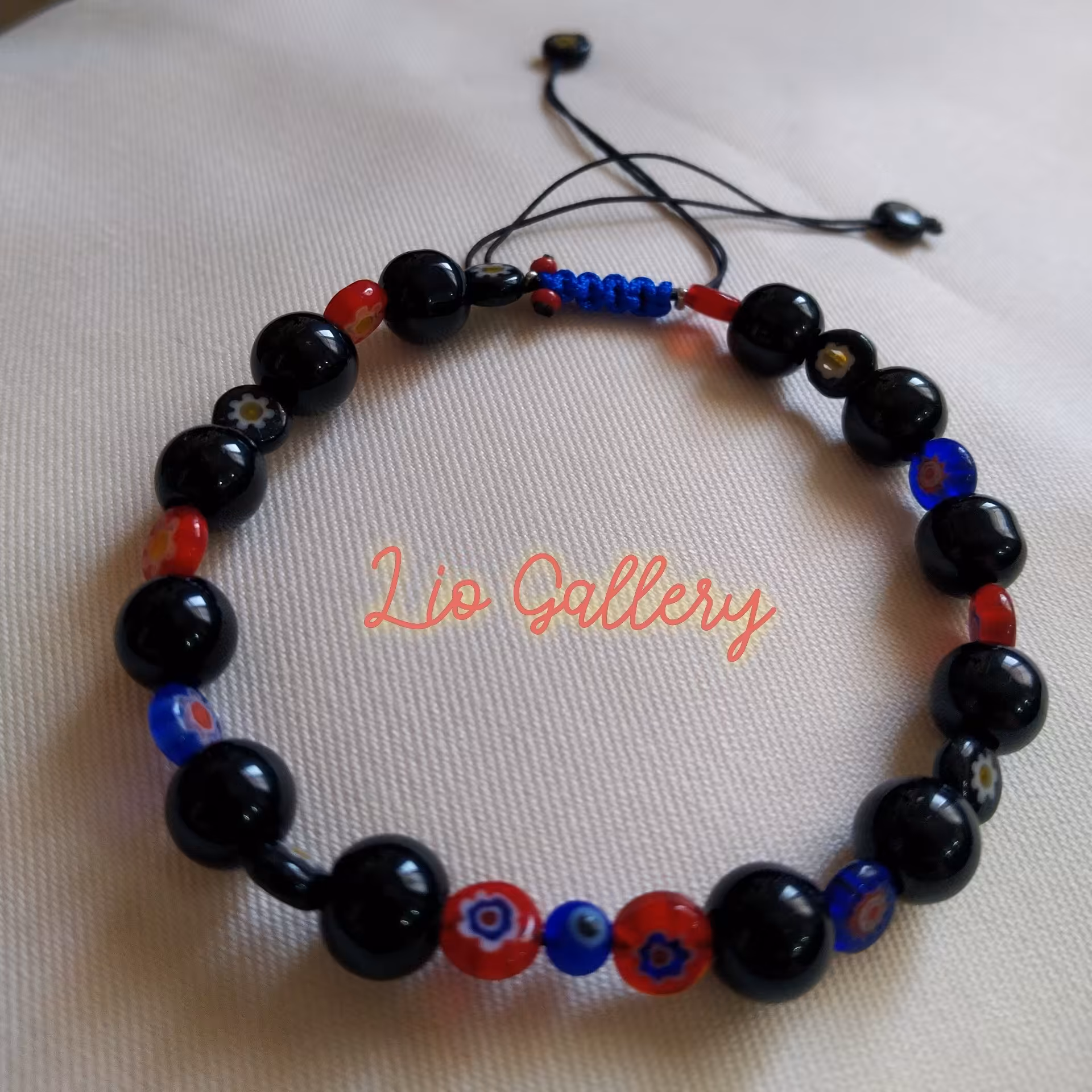 دستبند مهره ای چشم نظر سنگ انیکس مشکی و مهره شیشه ای عدسی