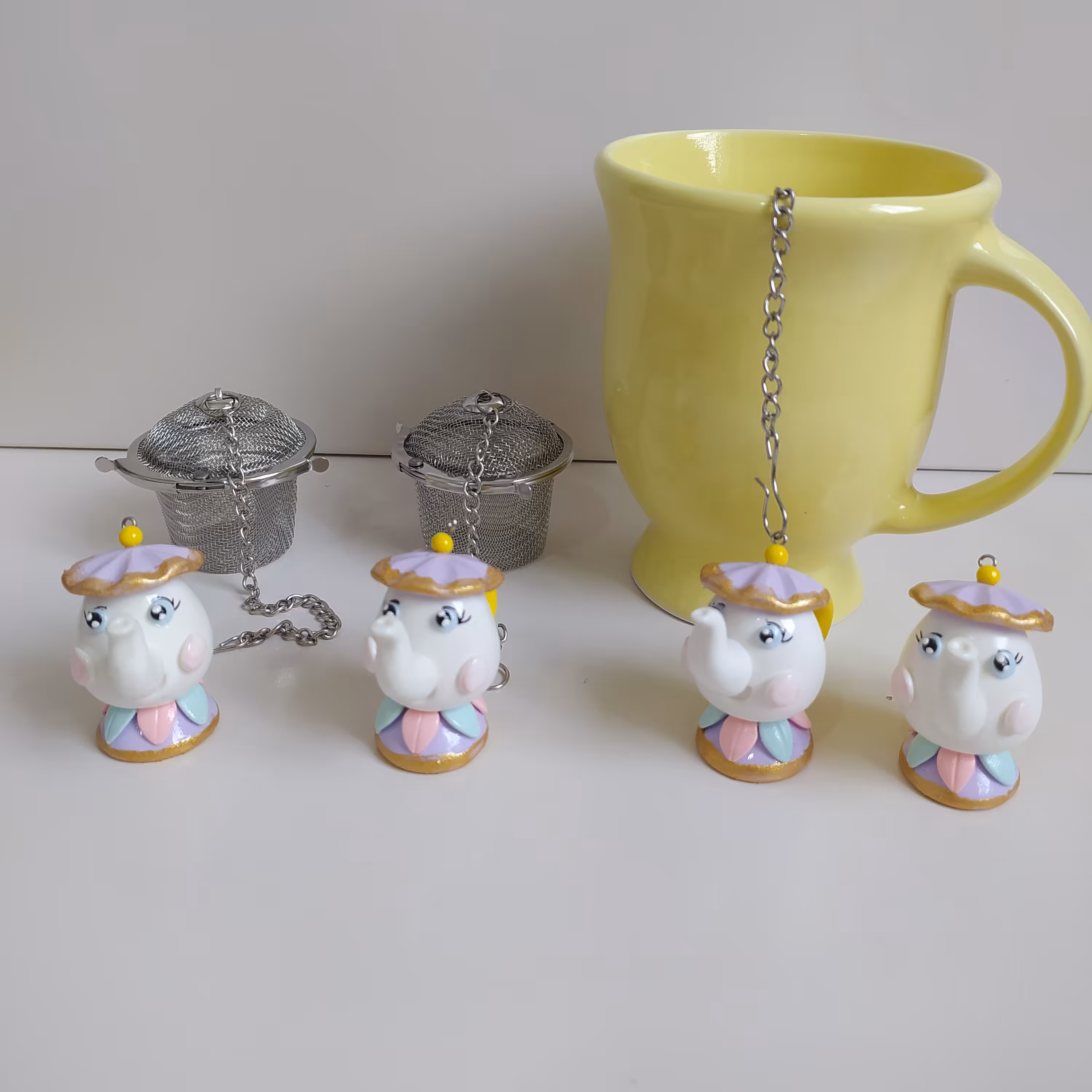 آویز صافی چای و دمنوش طرح قوری دیو و دلبر یک عددی بدون صافی استیل 