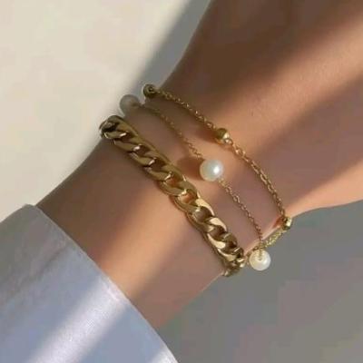 دستبند استیل و رنگ ثابت سه ردیفهکارتیر و مروارید و زنجیر توپی