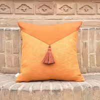 کوسن مربعی نارنجی منگوله دار با ابعاد 40 در 40