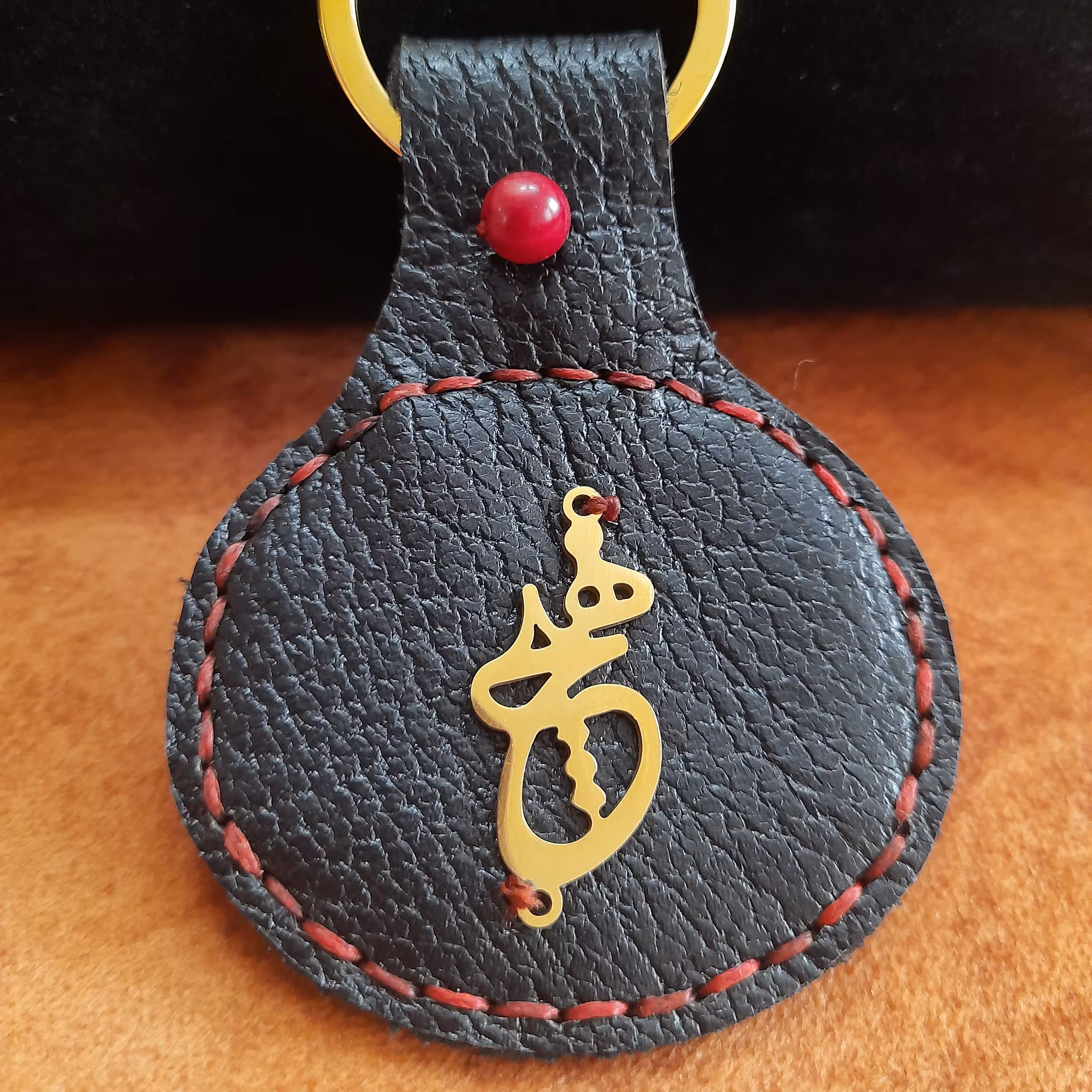 جاسوئیچی چرم طبیعی دستدوز همراه با سنگ عقیق سرخ