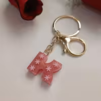 سرکلیدی و آویزکیف حرف انگلیسی رزینی رنگ ثابت و بدون حساسیت حرفK رزگلد با فیمو برف صورتی 