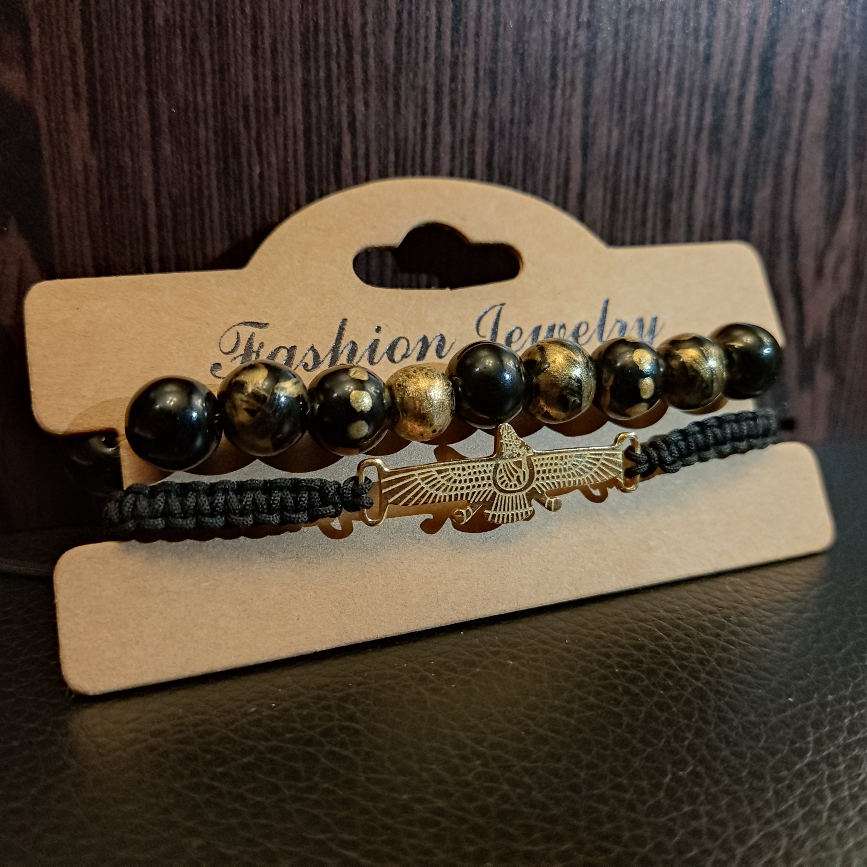 دستبند سنگ و بافت پلاک فروهر مشکی طلایی درشت